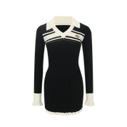 Black dress with white collar and cuffs on a white background