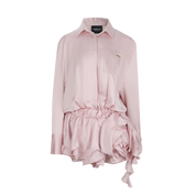 Pink shirt and shorts set with ruffled details on a white background