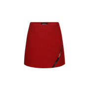 Red skirt with a black zipper on a white background
