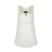 White dress with floral embellishments on a white background